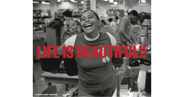 Black and white image of a smiling woman with text overlaid in red that reads: &quot;Life is beautiful!!&quot;