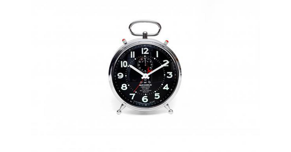 A silver and black analog alarm clock with the time at 10:10.