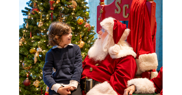 A boy sits on Santa&#039;s lap at the Carter.