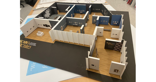 A very detailed gallery model showing graphics, painted walls, and artwork for a Carter exhibition.