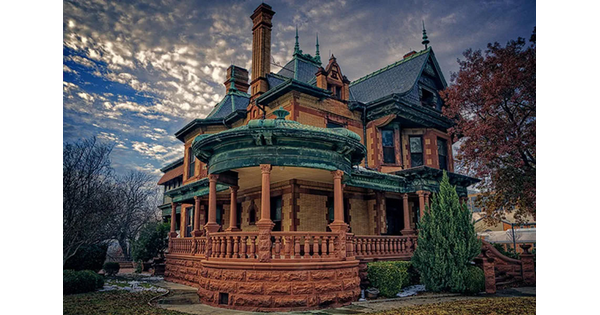 A Victorian "painted lady" style house with a huge wrap-around porch.