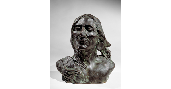A bronze bust of an Indigenous person.