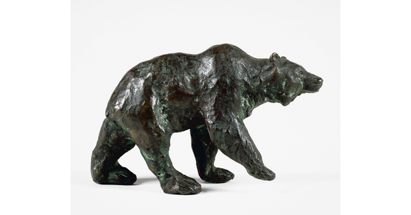 A bronze sculpture of a walking bear.