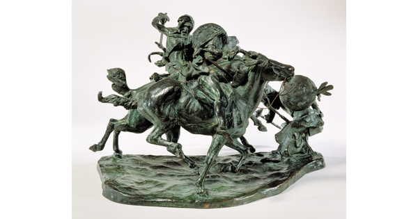 A bronze sculpture of two horses in mid-gallop, with both riders lunging toward a crouching man behind a shield.