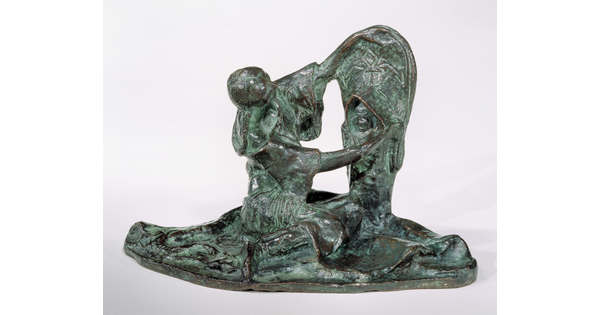 A bronze sculpture of a Native American woman looking at a child propped upright in a cradleboard.