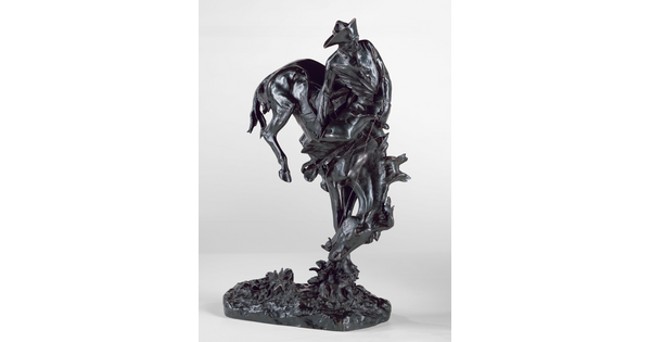 A bronze sculpture of a cowboy hanging onto a bucking bronco.