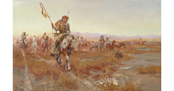 A Native American man wearing elaborate clothing leads a group on horseback through the plains.