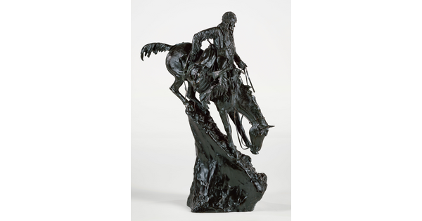 A bronze sculpture of a man going down a very steep mountain on horseback.