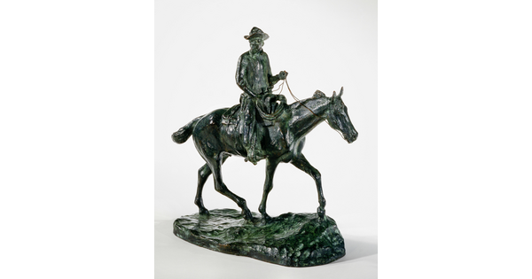 A bronze sculpture of a man wearing a cowboy hat seated on a walking horse.