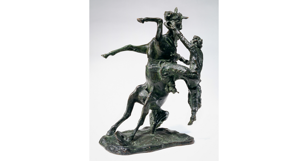 A bronze sculpture of a cowboy falling off the back of a rearing horse.