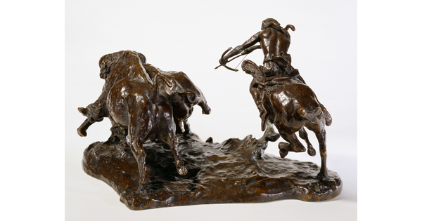 A bronze sculpture of a Native American on horseback hunting bison with a bow and arrow.