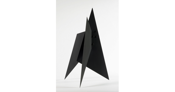 A black abstract tabletop sculpture with lots of triangular points.