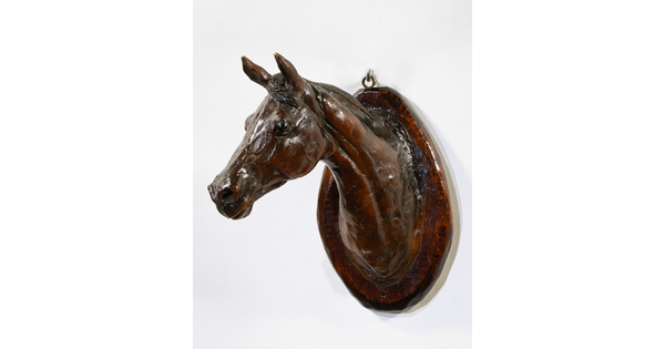 A wood mount of a horse's head and neck.
