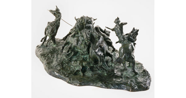 A bronze sculpture of two Native men, one with a spear and the other with a bow, on horseback circling a group of bison.