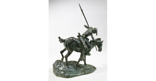 A bronze sculpture of an Indigenous man on horseback holding a spear pointed toward the ground as he studies footprints there.