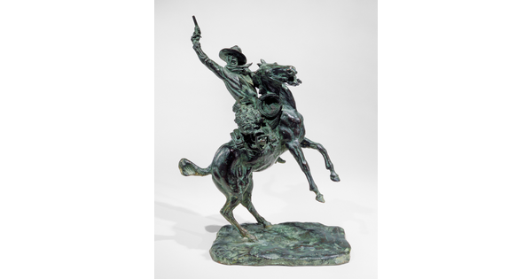 A bronze sculpture of a man pointing a gun up high over his head while on a rearing horse.