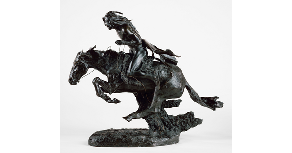 A bronze sculpture of an Indigenous man riding a running horse.