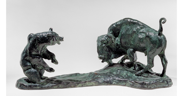 A bronze sculpture of a bison and a bear facing off.
