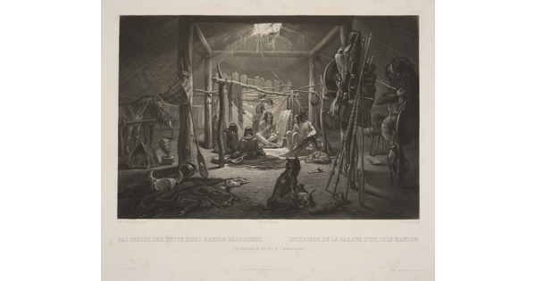 A black-and-white print of several Indigenous people, dogs, and horses inside of a wood structure; hunting equipment, hides, and other items scattered around.