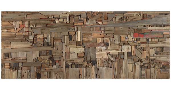 A flat abstract assemblage of wood pieces in various shapes, sizes, and colors fitted together perfectly like puzzle pieces.