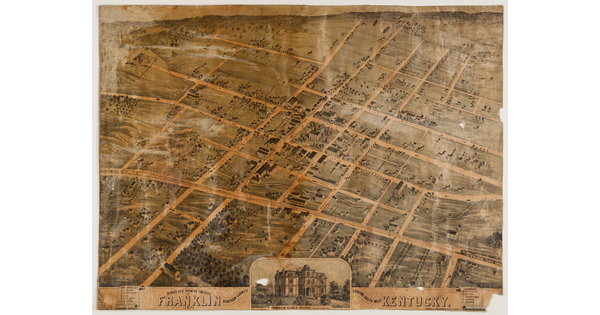 A worn and stained color print of an aerial view of a city, showing the grid of streets, map text and key at bottom, along with an inset image of a large house.