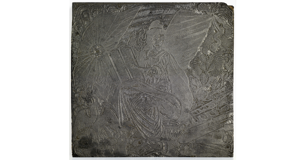 An engraved metal printing plate of a seated woman holding a book, a flag in the background, and a large bird in the lower left.