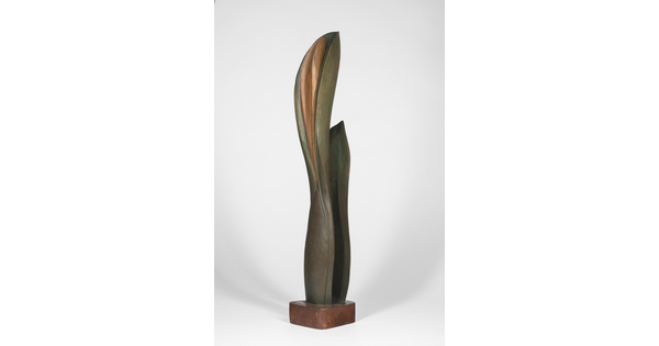 A wood sculpture of a tall, thin leaf with two smaller leaves on either side.
