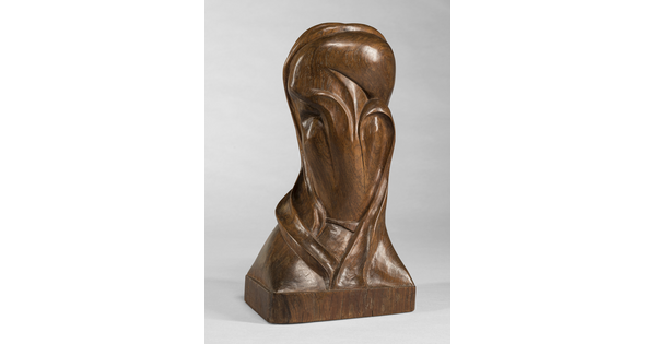 A mahogany sculpture representing an abstracted head.