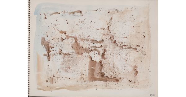 An abstract watercolor of sepia-toned splatters on a page of a bound sketchbook.