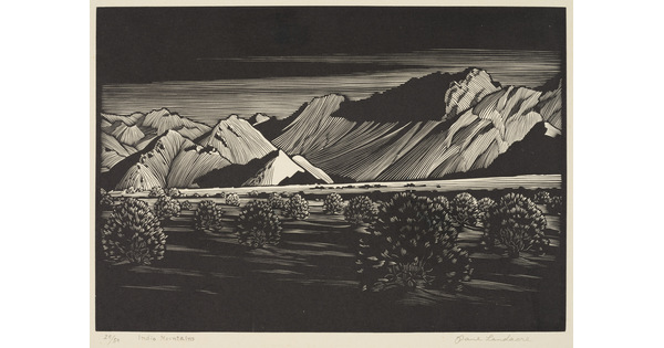 A black-and-white print of tall mountains beyond a desert landscape filled with low vegetation.