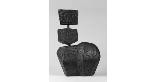 A black ceramic sculpture of three abstract, rectangular shapes, the largest on the bottom, connected vertically by a rod.