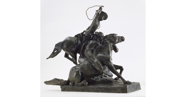 A bronze sculpture of a cowboy on horseback who is about to lasso another horse, its rider holding onto its neck, that is on the ground.