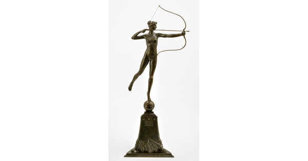 A bronze sculpture of a nude goddess shooting a bow and arrow from on top of a pedestal.