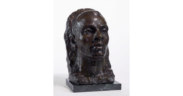 A bronze bust of a Black man emerging from a heavily textured background.