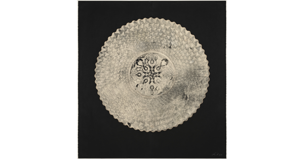 An abstract, mostly flat creation of a white circular shape filled with intricate geometric patterns that resemble lace on a black background.