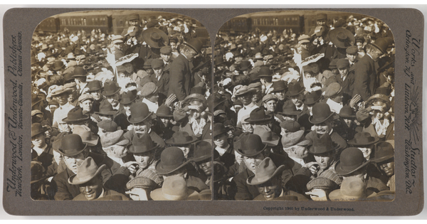 Two almost identical side-by-side black-and-white photographs of a large crowd of people, most wearing hats.