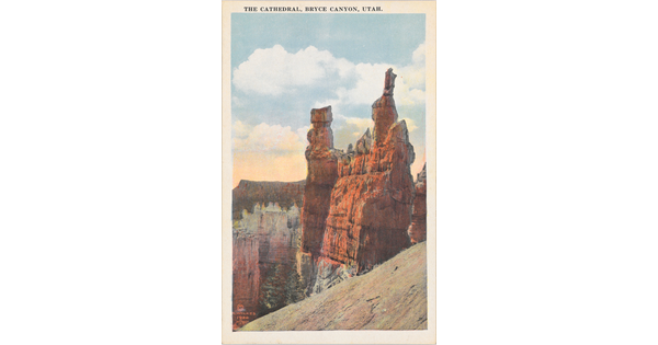 A color postcard of vertical rock formations in a desert landscape.