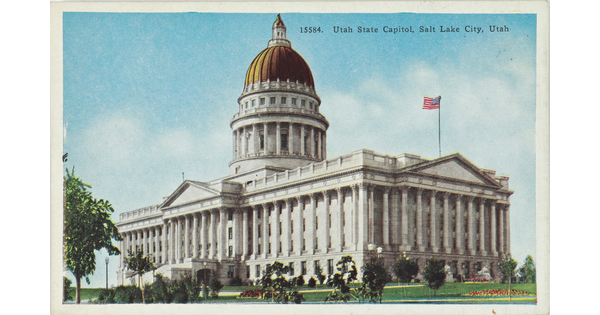 A color postcard of a gold domed government building with many columns.