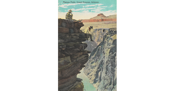 A color photograph postcard of two people, one sitting at the top edge of a cliff and the other on an outcrop of rocks that overlooks a deep canyon with a river at the bottom.