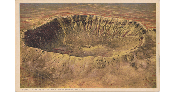A color postcard of a bird's eye view of a large crater in a rocky desert landscape.