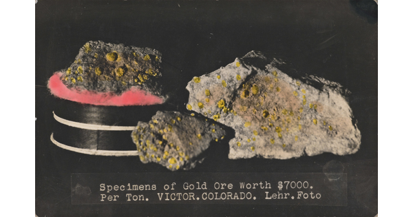 A color postcard of multiple nuggets of gold on a black background.