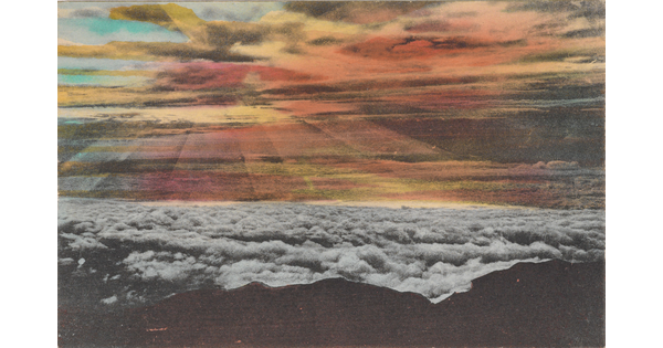 A color photograph postcard of dark mountains above a layer of white clouds and colorful streaks of light coming from clouds in the sky.