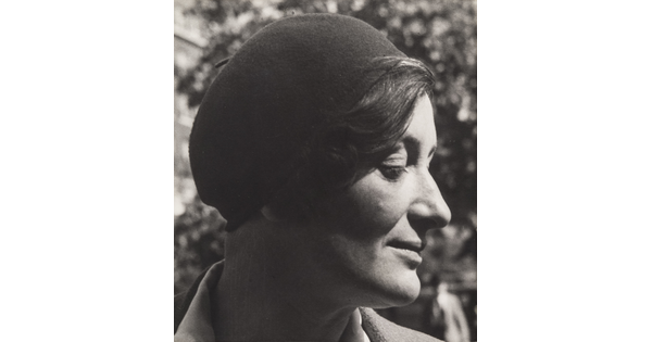 A black-and-white portrait photograph of a White woman in profile wearing a beret.