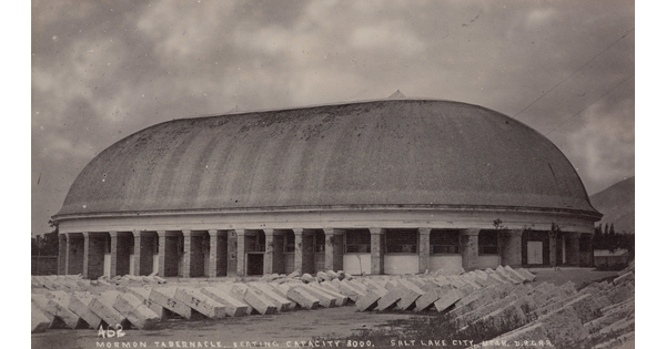 A black-and-white photograph of a large, oval-shaped building with a dome.