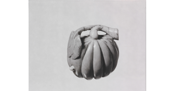 A black-and-white photograph of a ceramic pumpkin.