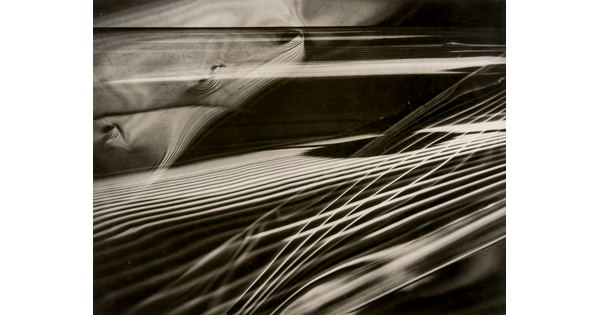 An abstract black-and-white photograph of layered sets of parallel rays of light that resemble guitar strings intersecting with one another.