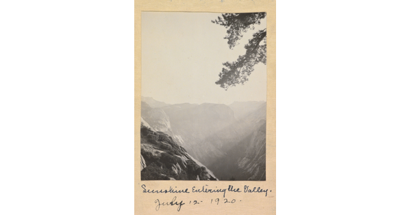 A black-and-white photograph of a mountainous landscape on a sunny day, labeled "Sunshine Entering the Valley, July 12, 1920."