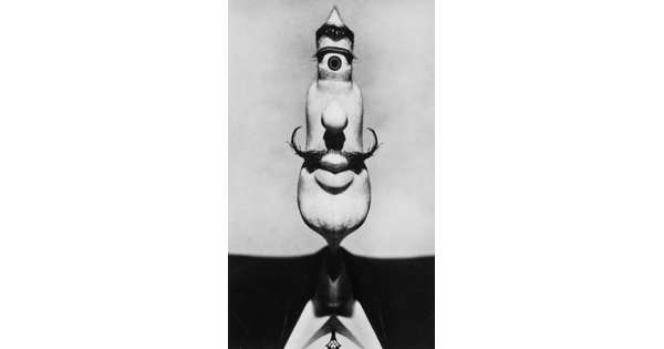 An abstract black-and-white photograph of a man's elongated face with a single eye at the top of the head.