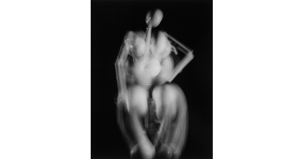 An abstract black-and-white photograph of what looks like an artist's mannequin that has been double-exposed to suggest movement.