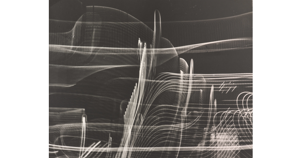 A black-and-white photograph of abstract streaks of white light swirling horizontally and vertically on a black background.